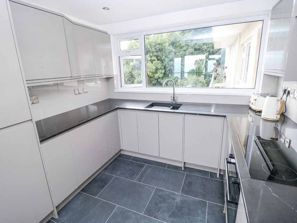 A kitchen with grey cabinets and countertop at Lifeboat Lookout in Tenby