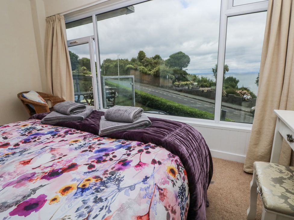 A bedroom with a bed and window view at Lifeboat Lookout in Tenby