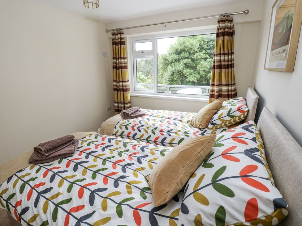 A bedroom with two beds and a window at Lifeboat Lookout in Tenby