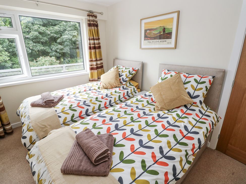 A bedroom with two single beds and a window at Lifeboat Lookout in Tenby