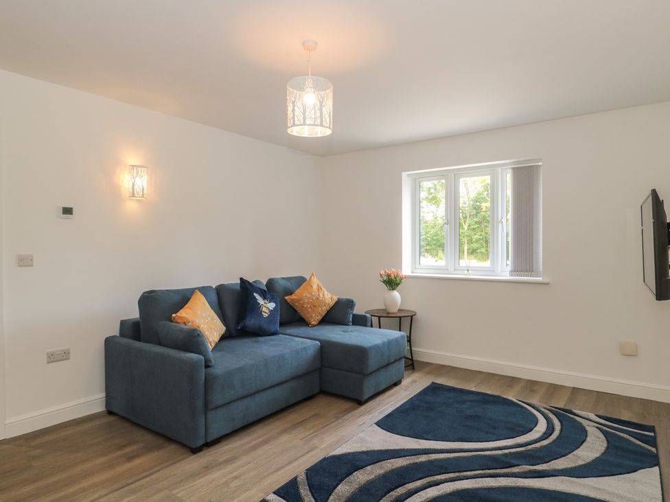 A living room with a sofa and a table at 1 The Stables in Highbridge