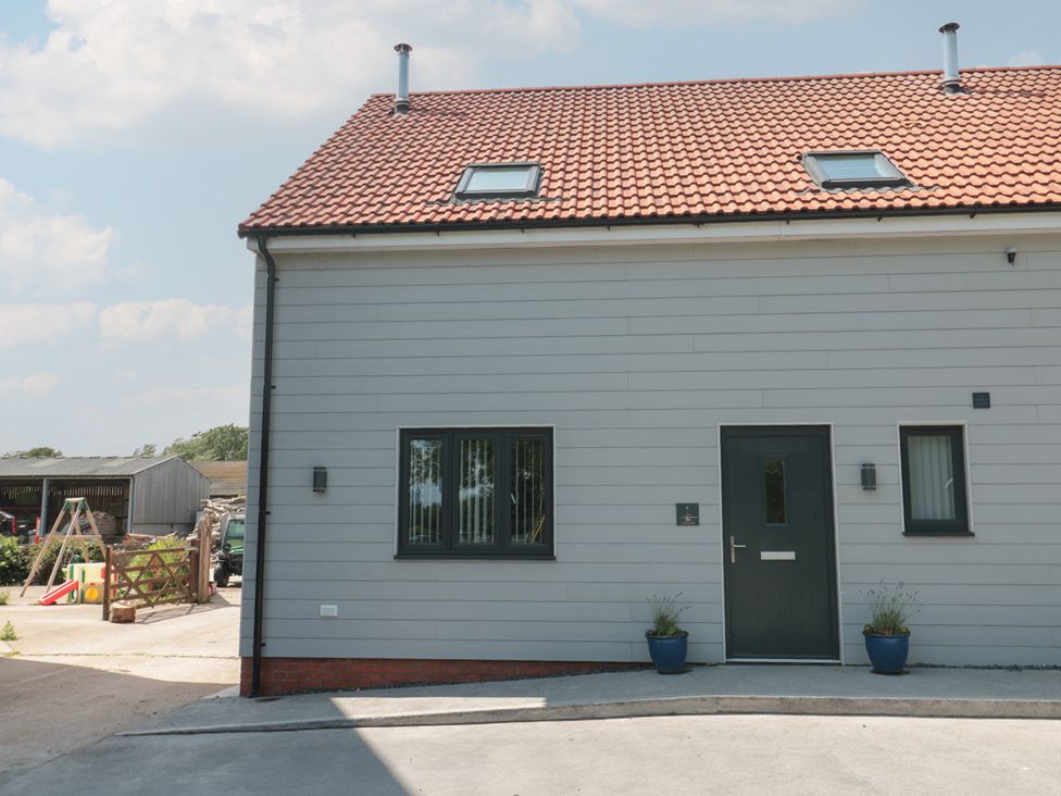 Front view of a house with a door and windows at 1 The Stables Highbridge