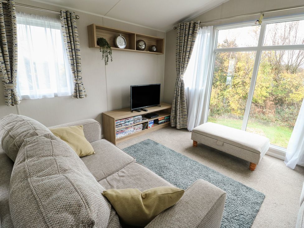 A living room with a sofa and television at No.22