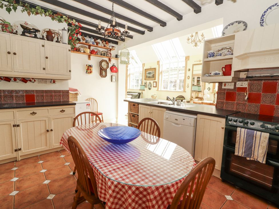 A kitchen with a round table and chairs at White Heather Cottage in Killalou