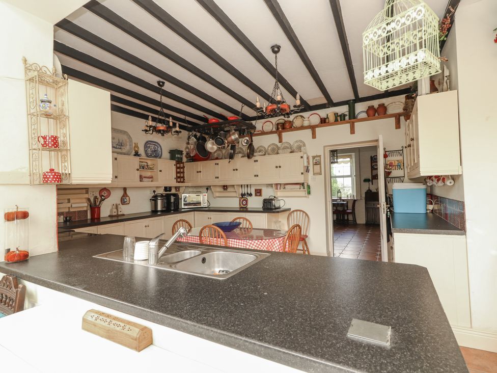 A kitchen with a sink and countertop at White Heather Cottage in Killalou