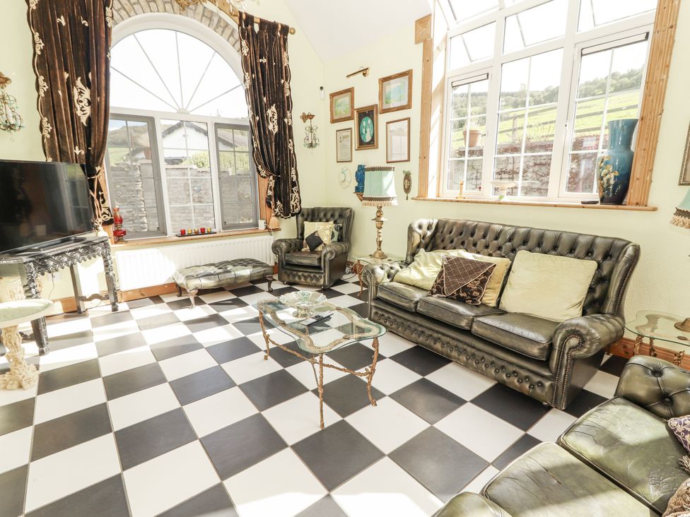 A living room with a sofa and coffee table at White Heather Cottage in Killalou