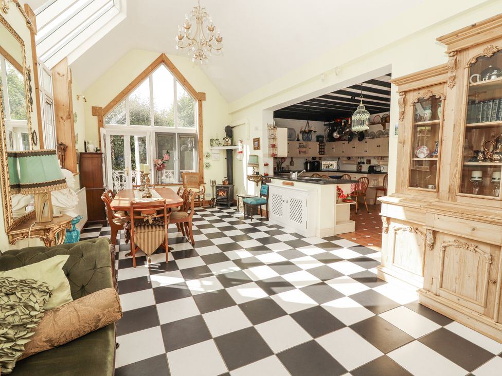 A dining room with a table and chairs at White Heather Cottage in Killalou