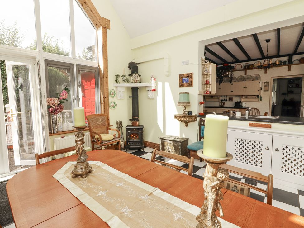 A dining room with a table and chairs at White Heather Cottage in Killalou