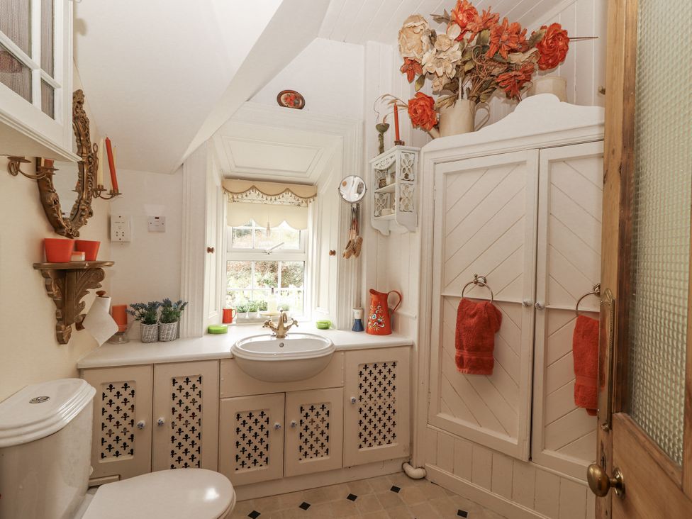 A bathroom with a sink and toilet at White Heather Cottage in Killalou
