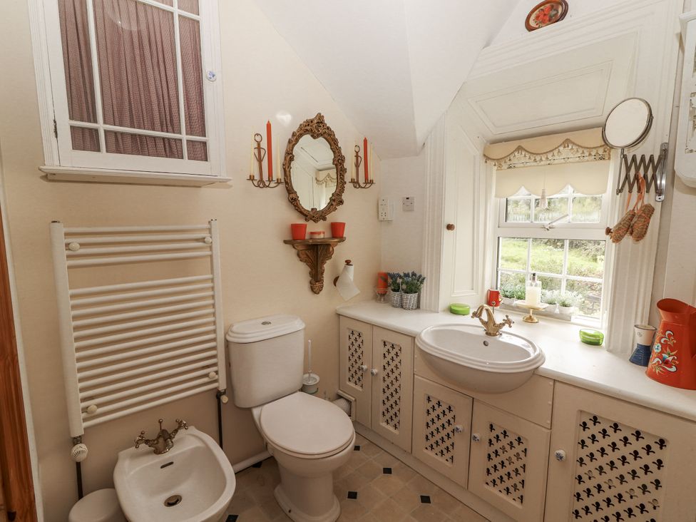 A bathroom with a sink and toilet at White Heather Cottage Killalou