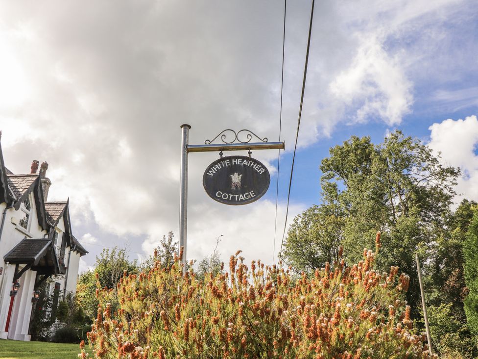 A sign for White Heather Cottage outdoors in Killalou
