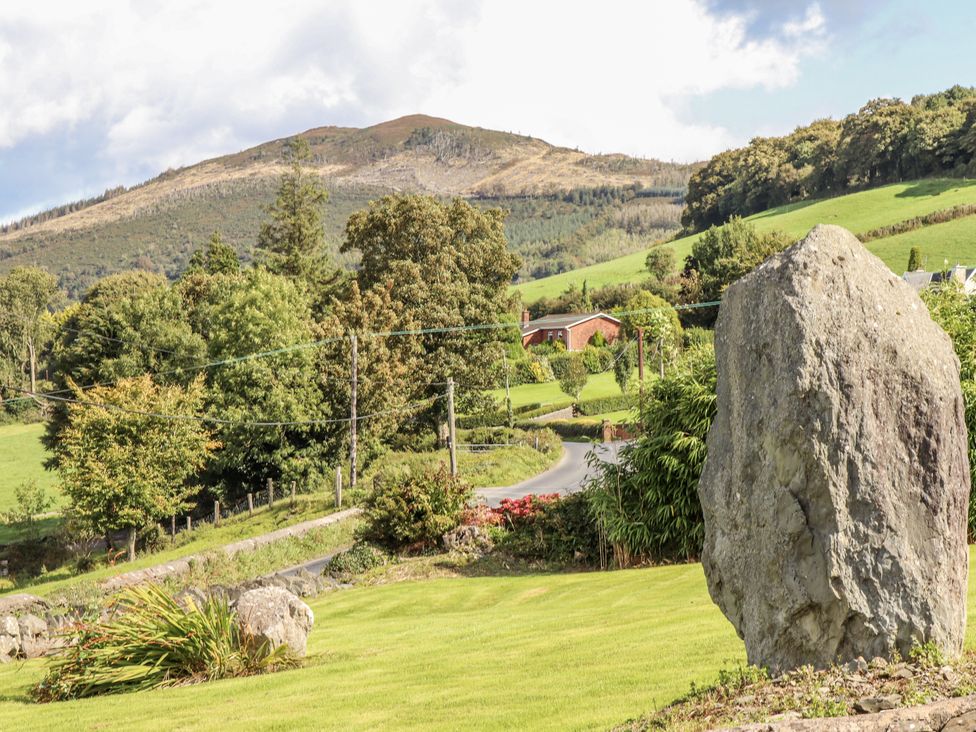 A landscape view with mountains and trees at White Heather Cottage in Killalou