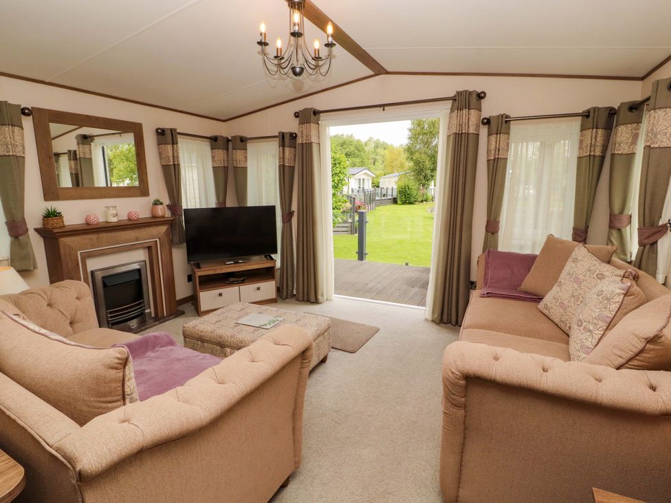 A living room with a sofa and television at 22 Yealand in Carnforth