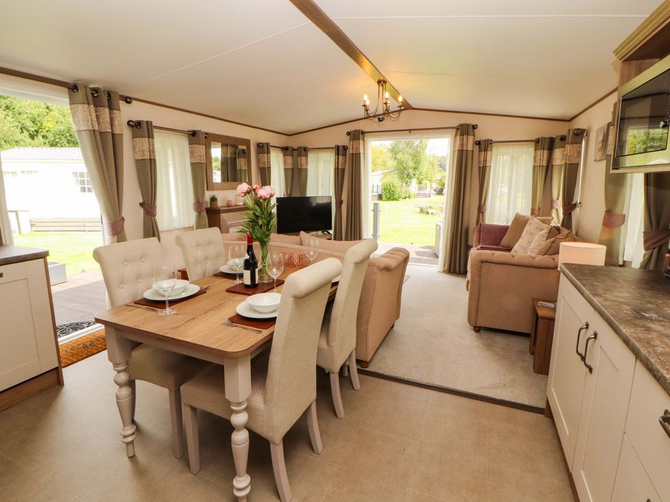 A living room with a dining area and sofa at 22 Yealand in Carnforth