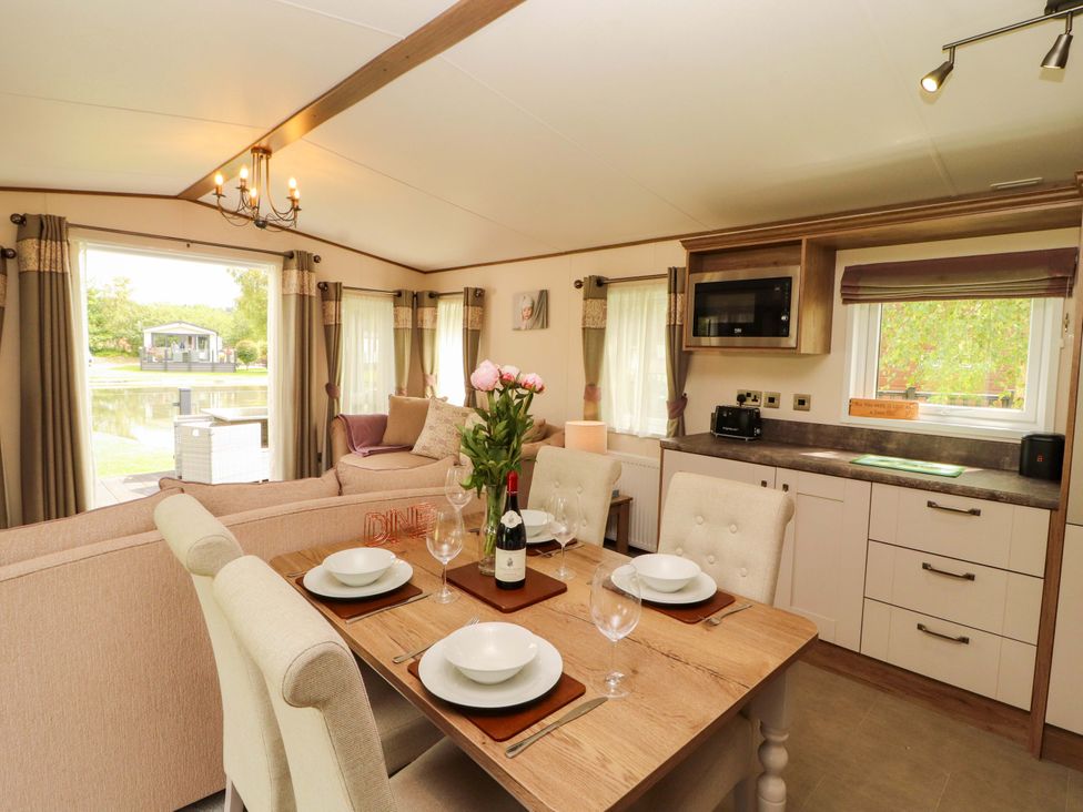 A dining area with table and chairs at 22 Yealand in Carnforth