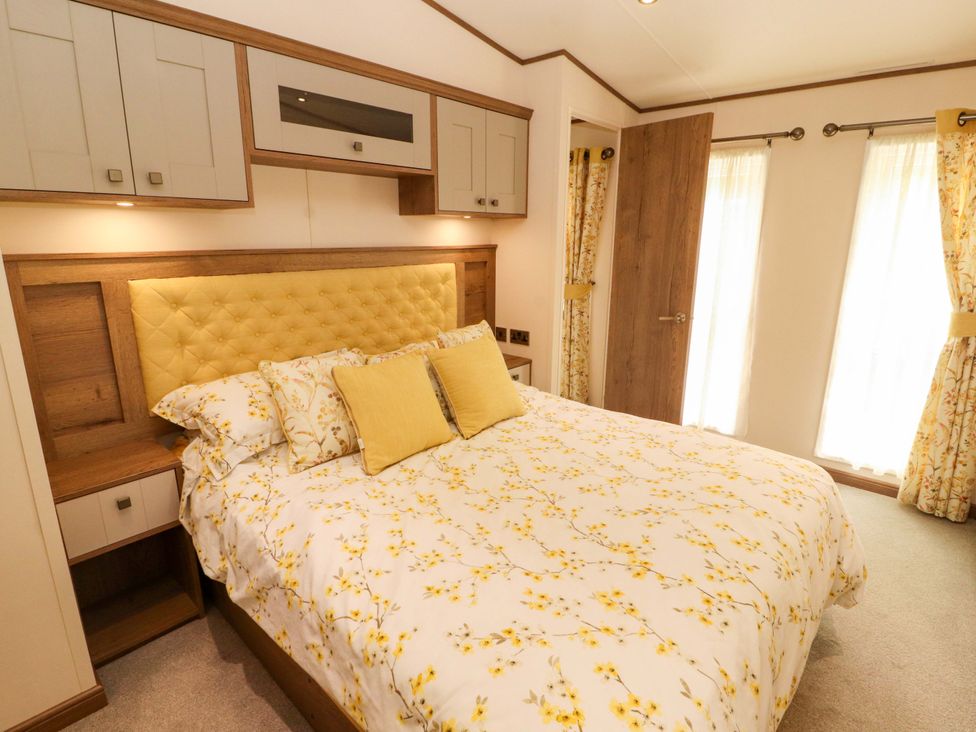 A bedroom with a bed and bedside table at 22 Yealand in Carnforth
