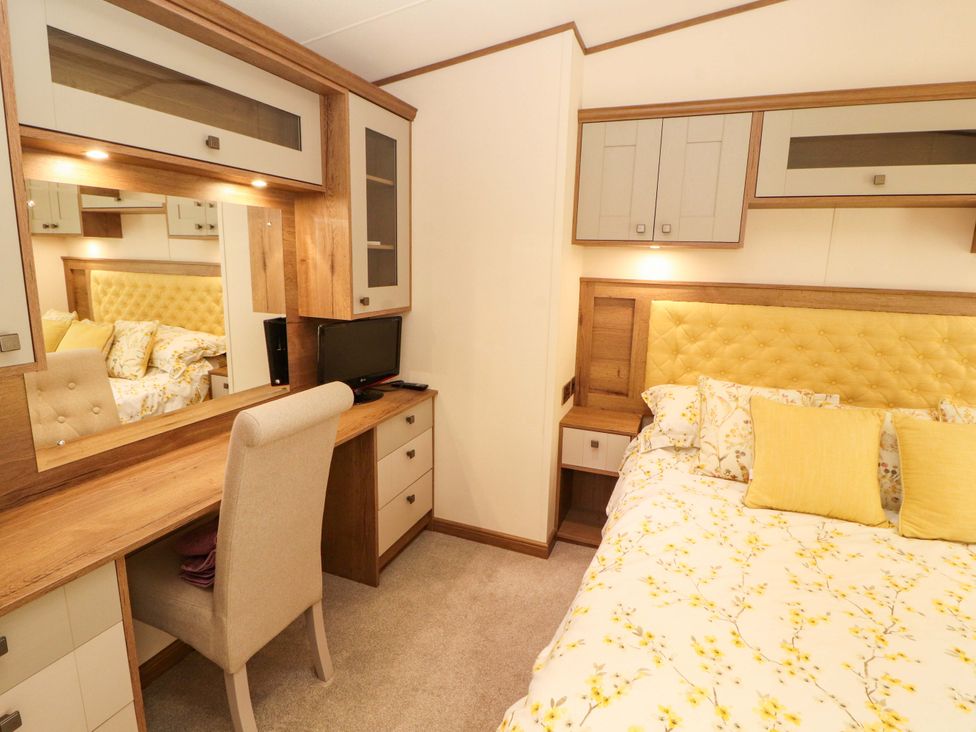 A bedroom with a bed and desk area at 22 Yealand in Carnforth