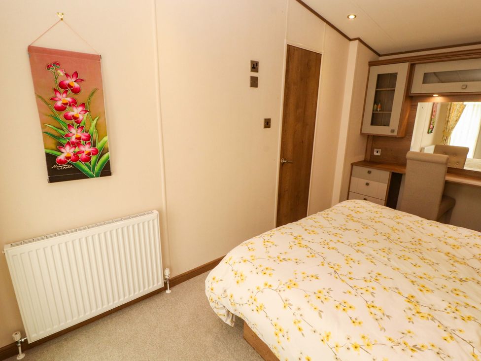 A bedroom with a bed and a desk at 22 Yealand in Carnforth