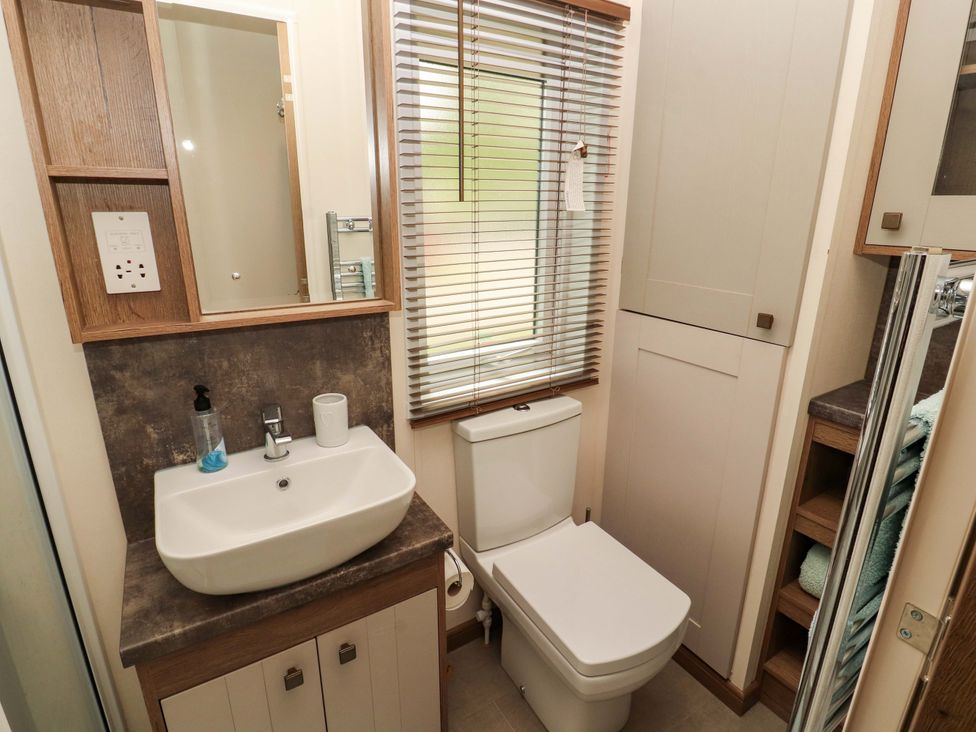 A bathroom with a sink and toilet at 22 Yealand in Carnforth