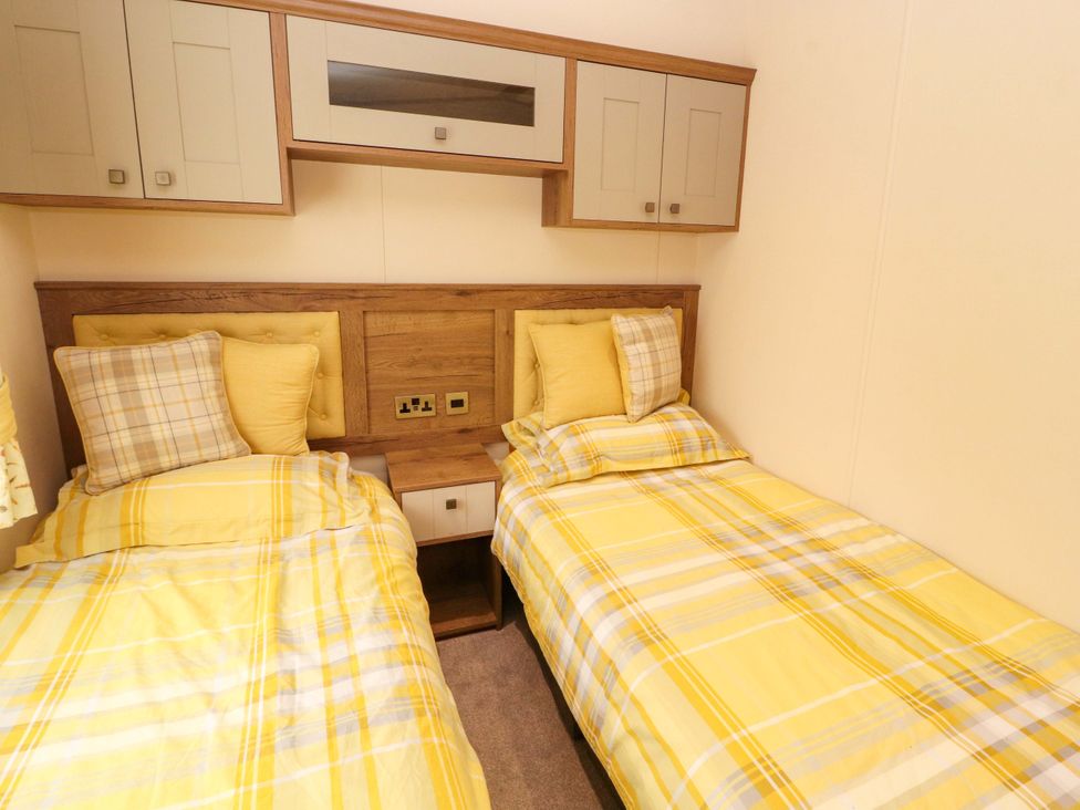 A bedroom with two single beds at 22 Yealand in Carnforth