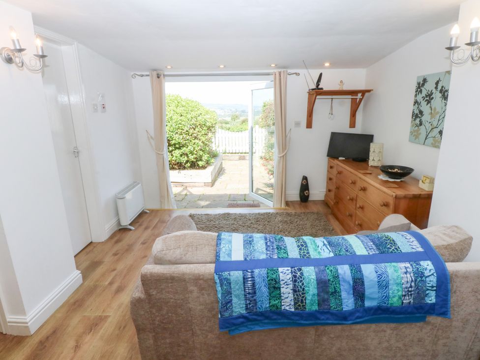 A living room with a sofa and television at Hafan Bach in Abersoch