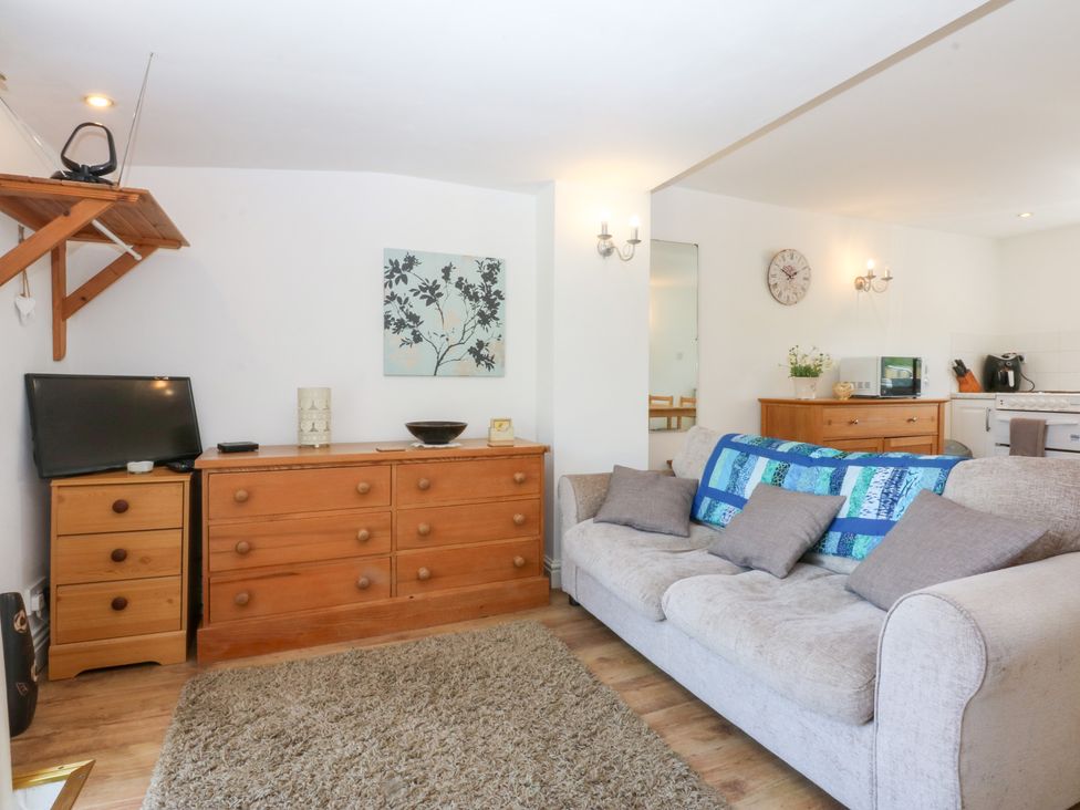 A living room with a sofa and television at Hafan Bach in Abersoch
