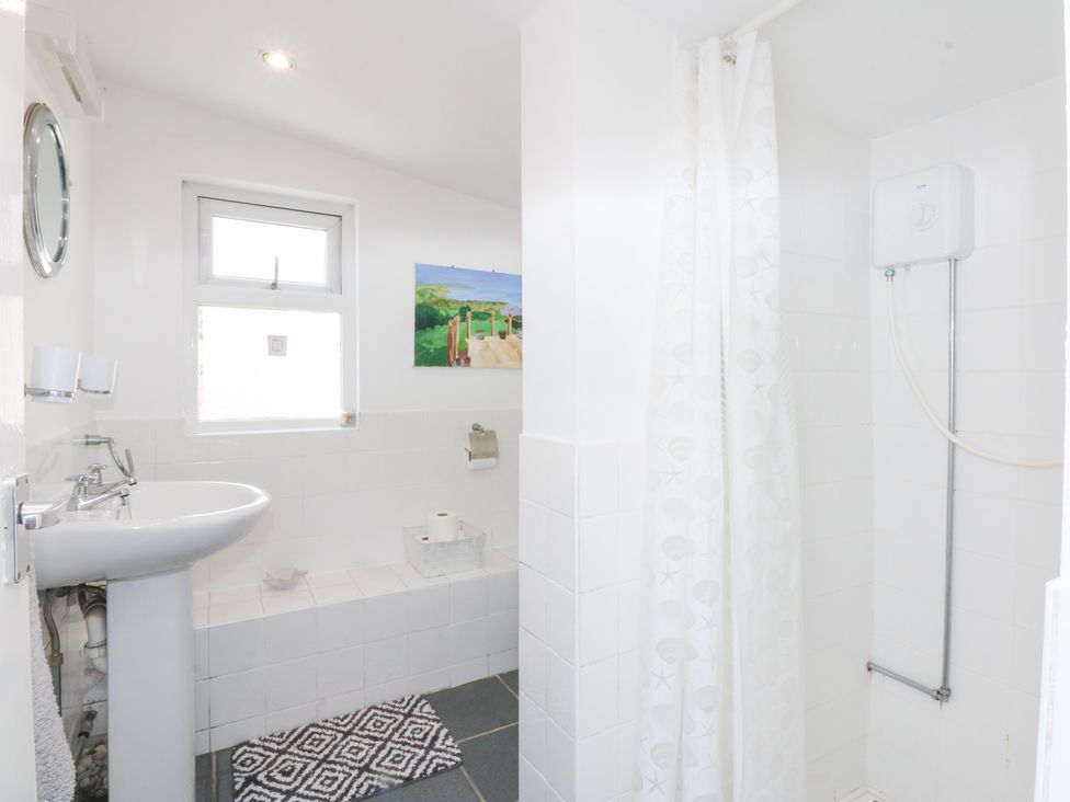 A bathroom with a sink and shower at Hafan Bach in Abersoch