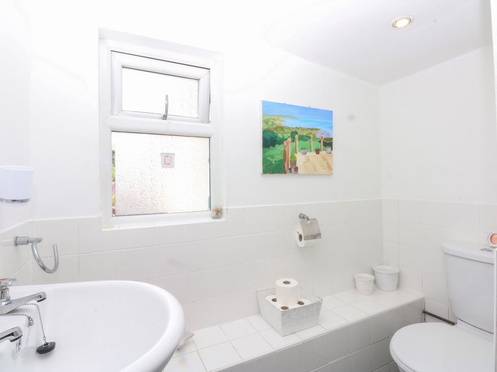 A bathroom with a sink and toilet at Hafan Bach in Abersoch