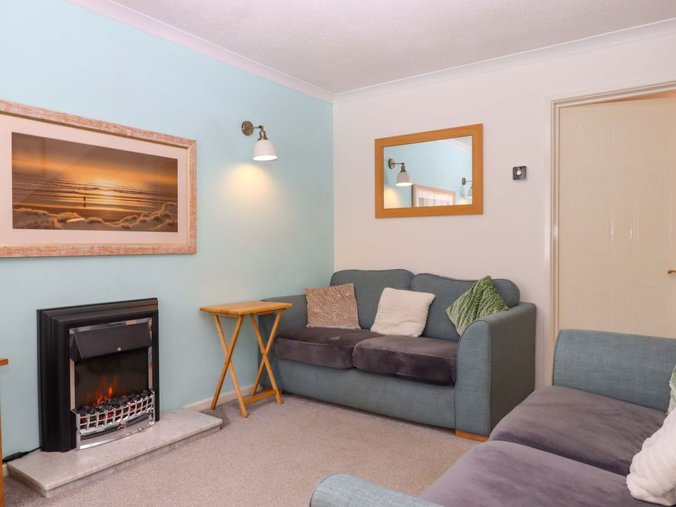 A living room with a sofa and fireplace at Hedgehogs in Barnstaple
