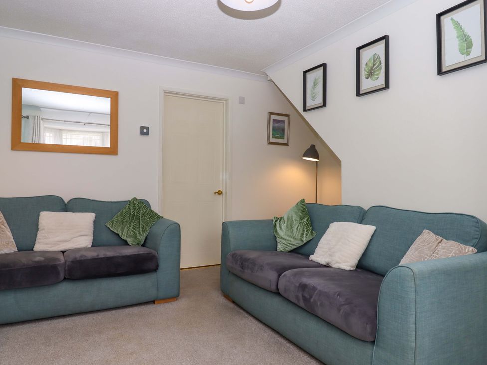 A living room with sofas and wall art at Hedgehogs in Barnstaple