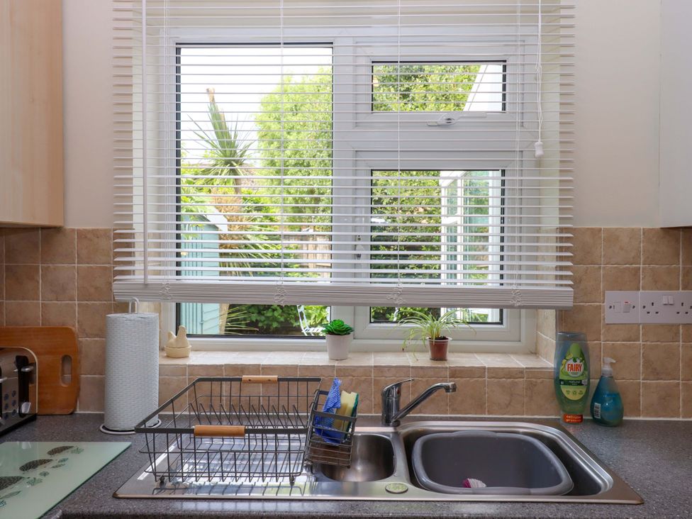 A kitchen with a sink and draining rack at Hedgehogs in Barnstaple