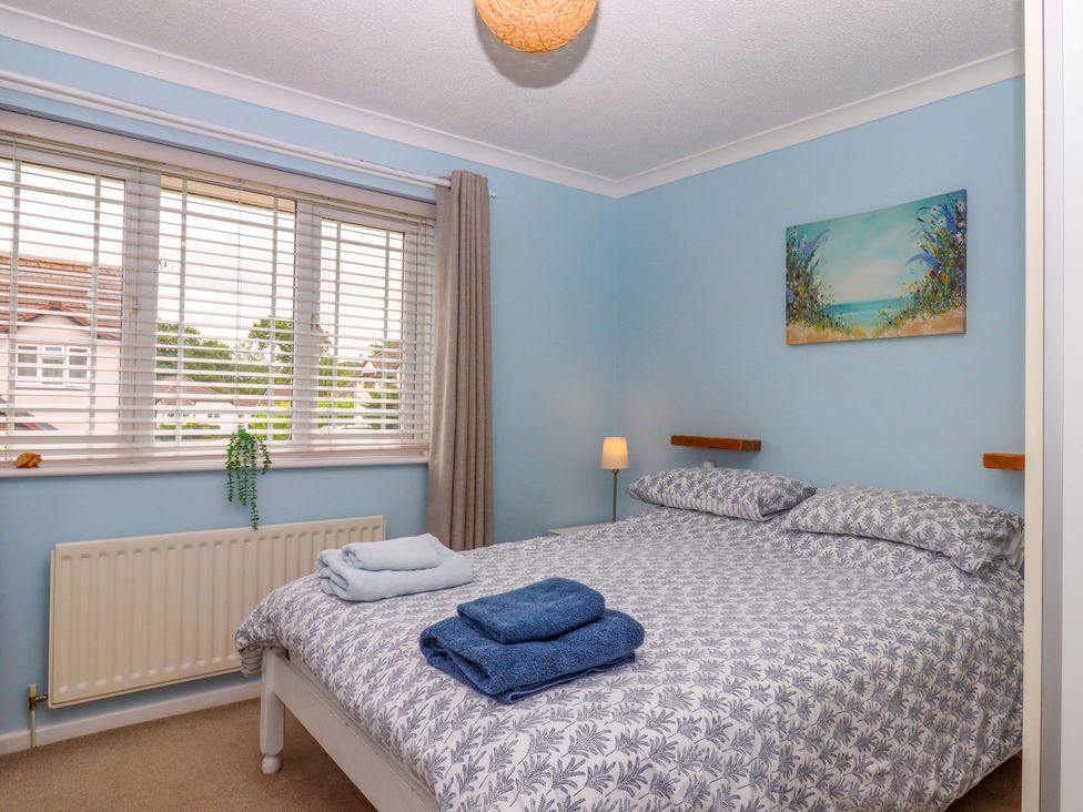 A bedroom with a bed and window at Hedgehogs in Barnstaple