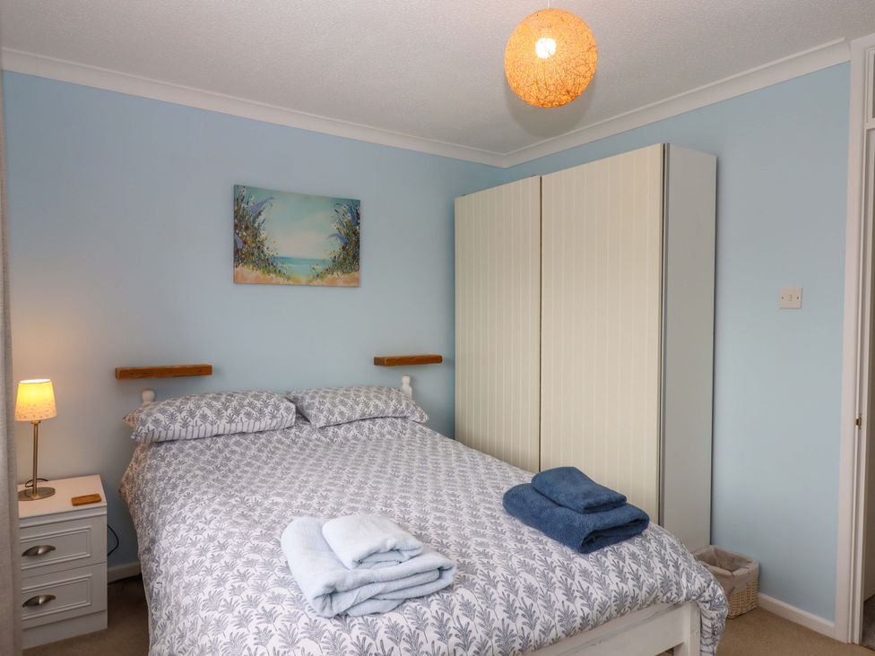 A bedroom with a bed and wardrobe at Hedgehogs in Barnstaple