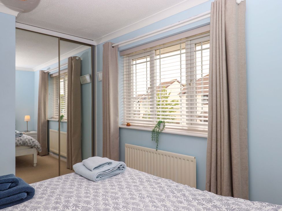 A bedroom with a bed and window at Hedgehogs in Barnstaple