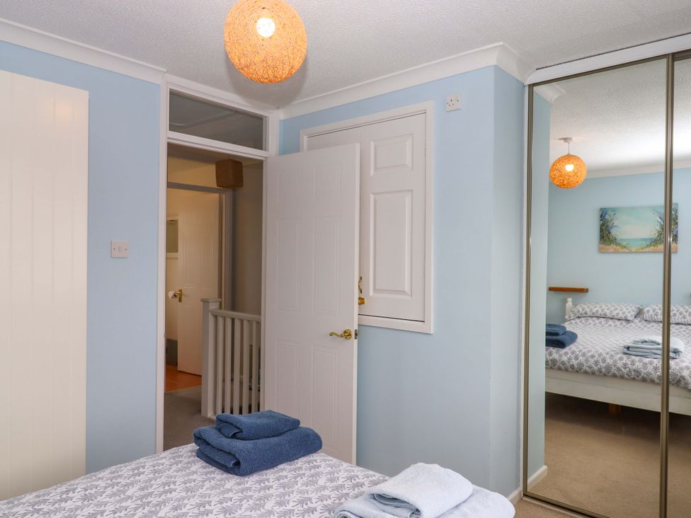 A bedroom with a bed and towels on a bed at Hedgehogs in Barnstaple