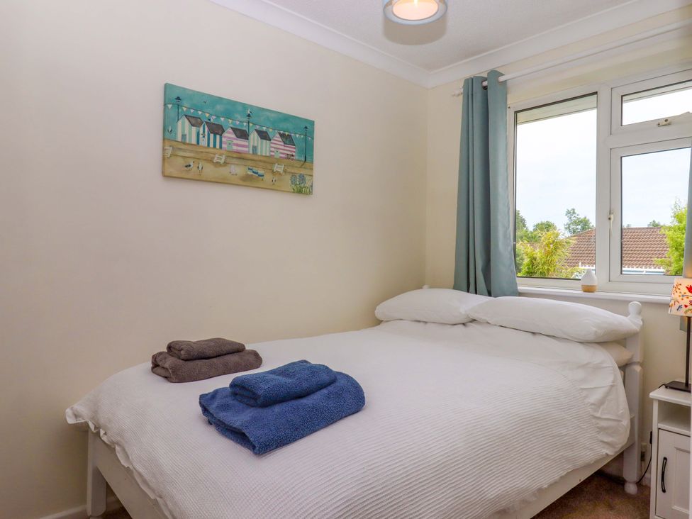 A bedroom with a bed and towels on it at Hedgehogs in Barnstaple