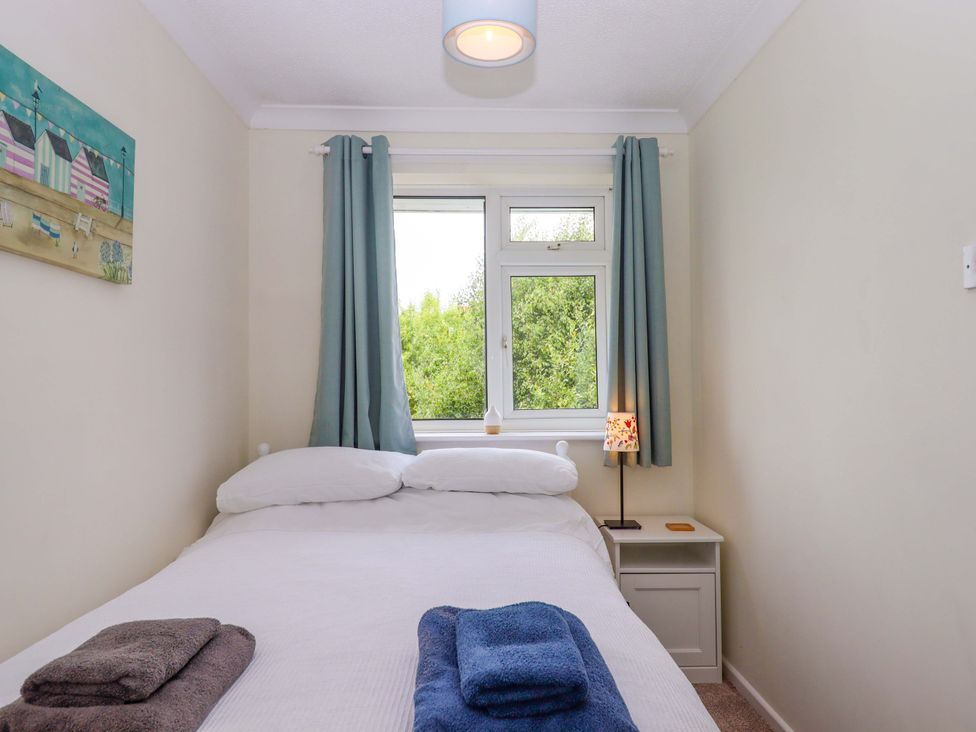 A bedroom with a bed and window at Hedgehogs, Barnstaple