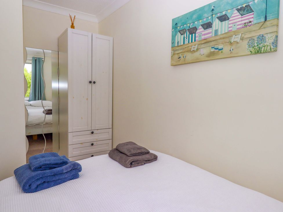 A bedroom with a bed and towels on it at Hedgehogs Barnstaple