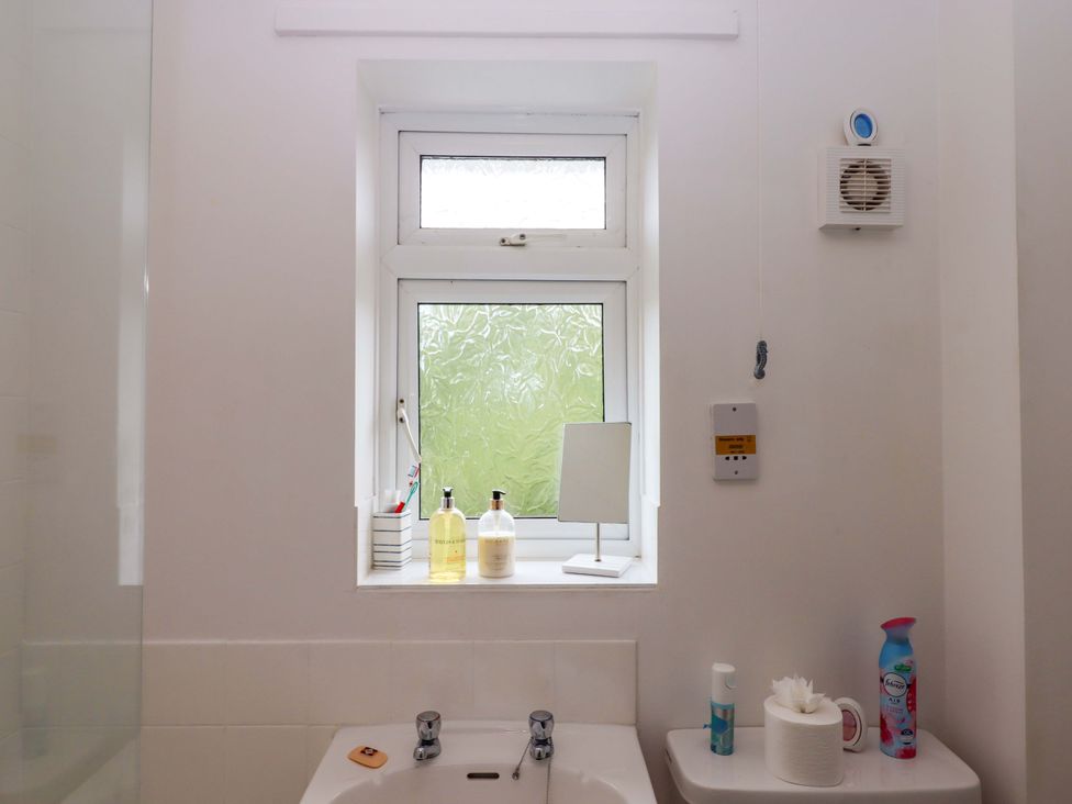 A bathroom with a window and sink at Hedgehogs in Barnstaple
