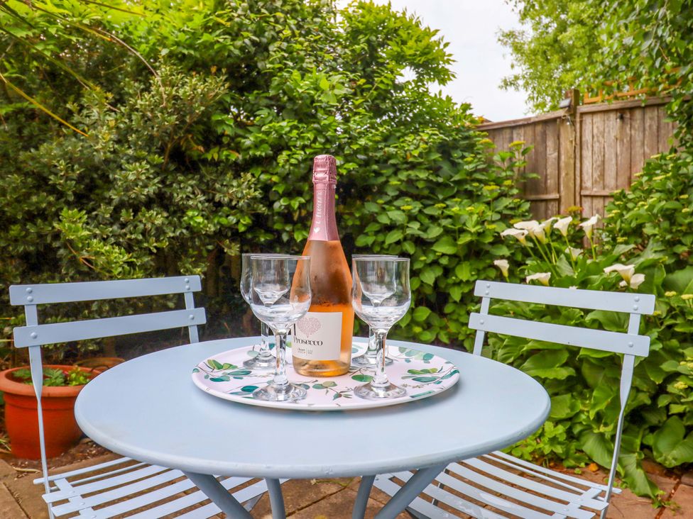 A table with champagne and glasses in the garden at Hedgehogs Barnstaple