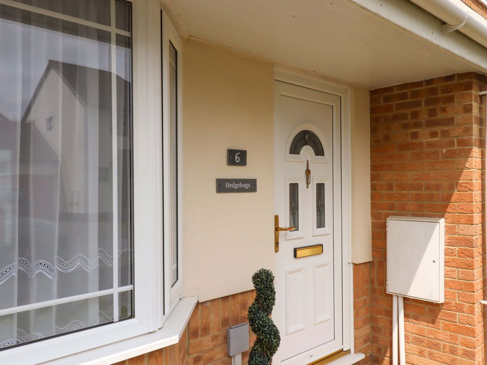 A front door with house number and sign at Hedgehogs in Barnstaple