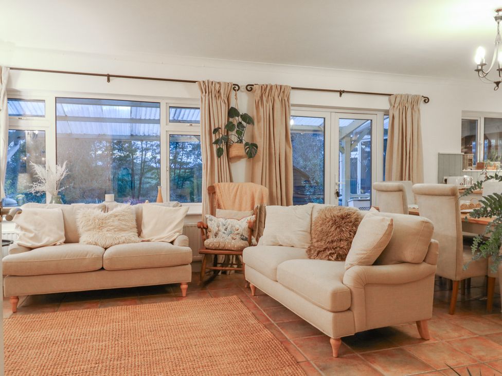 A living room with two sofas and an armchair at Berkley Cottage in Colchester