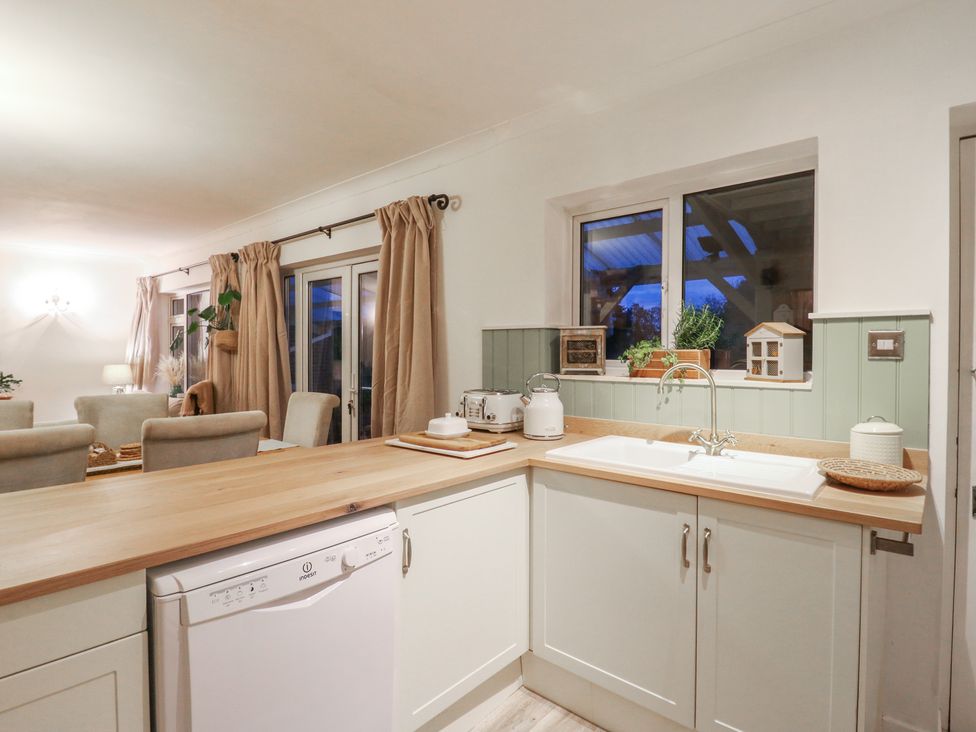 A kitchen with a sink and dishwasher at Berkley Cottage in Colchester