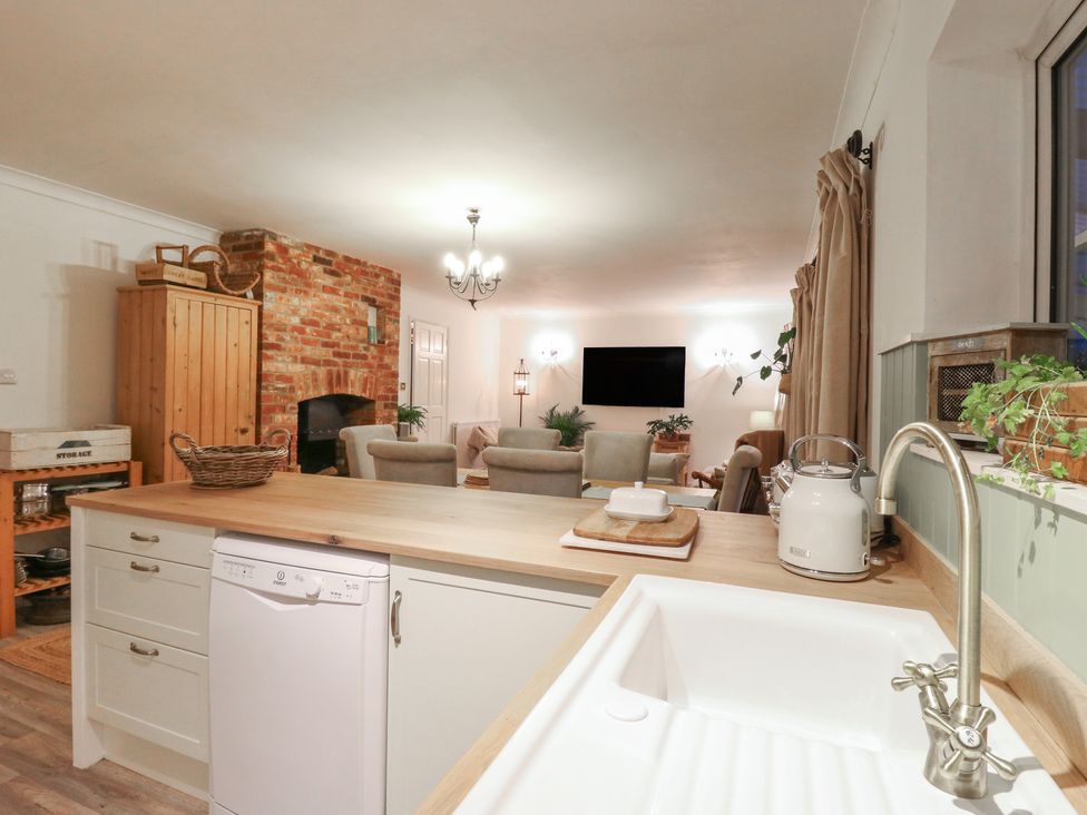 A kitchen with a dishwasher and sink at Berkley Cottage in Colchester