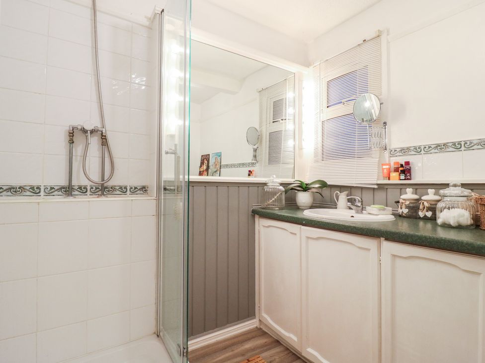 A bathroom with a shower and sink at Berkley Cottage in Colchester