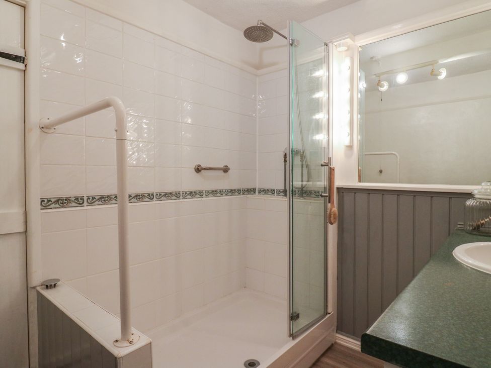 A bathroom with a shower and sink at Berkley Cottage in Colchester