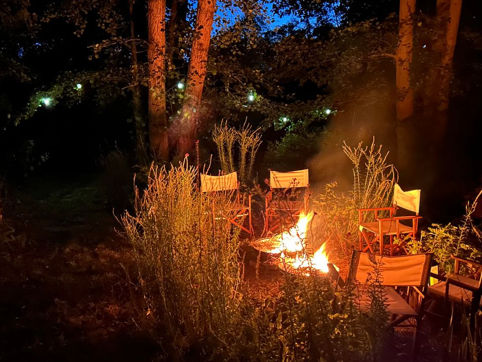 A fire pit surrounded by camp chairs at Berkley Cottage Coggeshall
