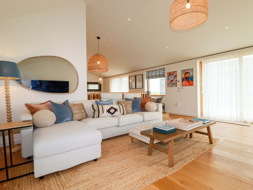 A living room with a sofa and coffee table at 8 Karn Havos St. Eval near Mawgan Porth