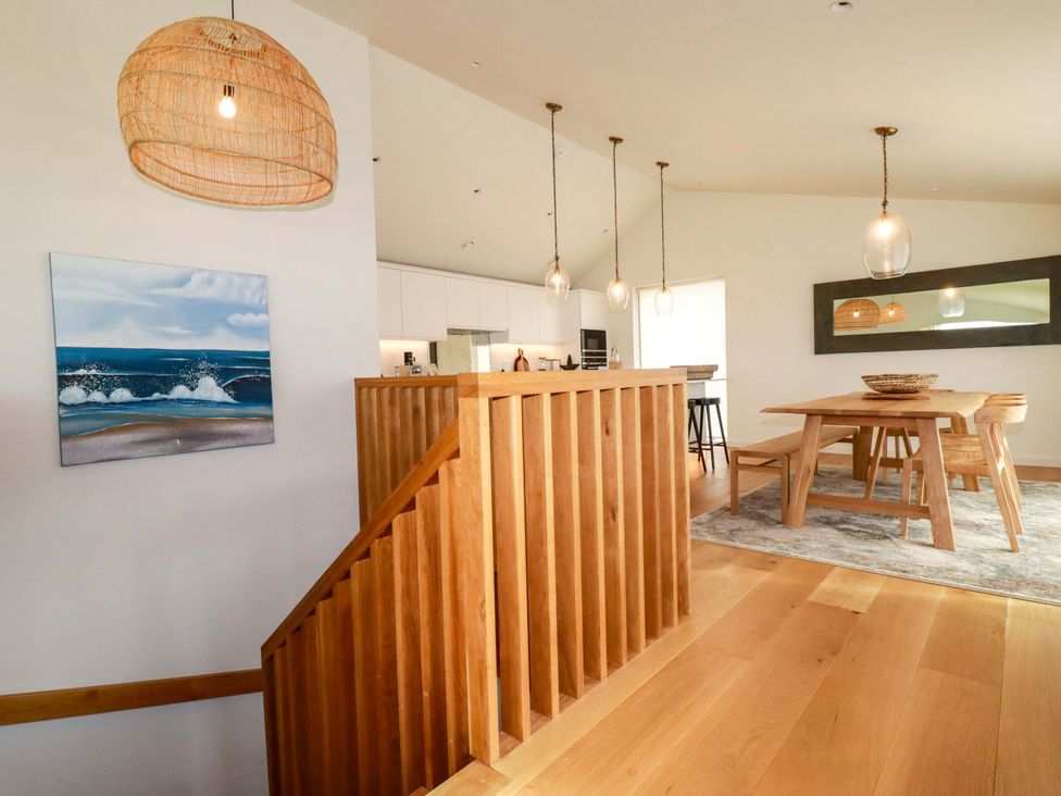 A dining room with a wooden table and chairs at 8 Karn Havos St. Eval near Mawgan Porth