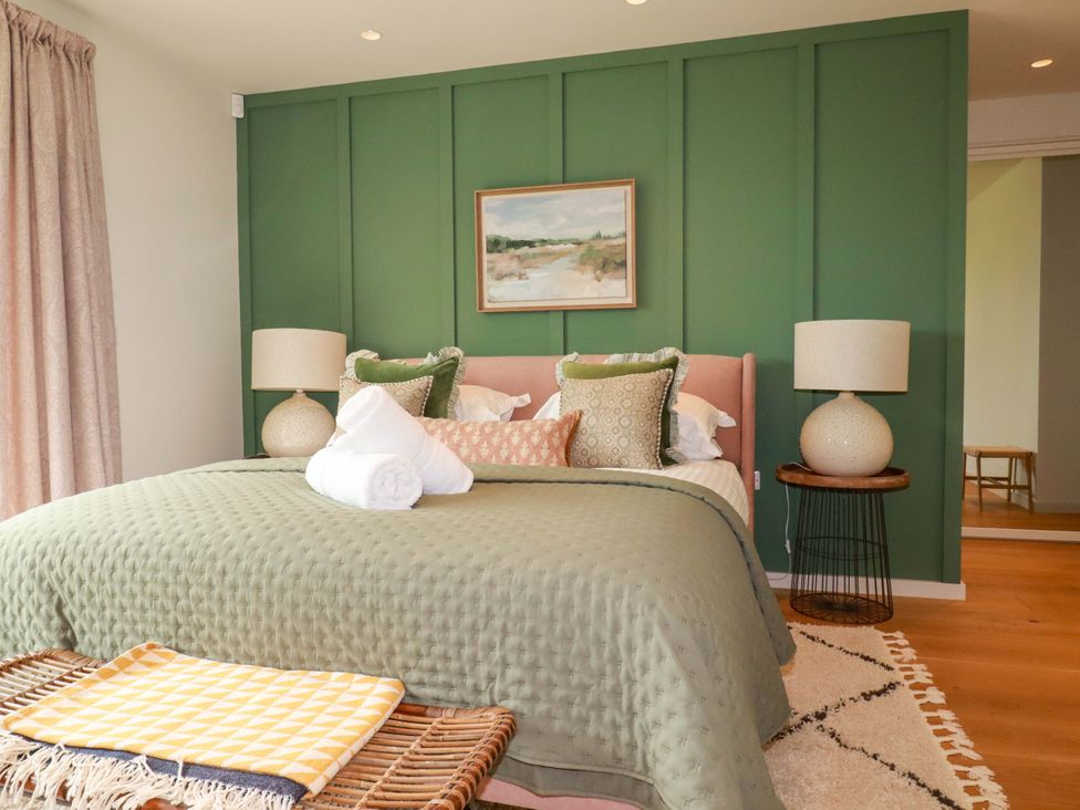 A bedroom with a bed and bedside lamp at 8 Karn Havos St. Eval near Mawgan Porth